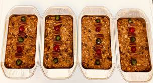 First of five batches of fruitcake. These will be popped out of the tins  when they cool and wrapped in rum-soaked cloths to age for four weeks.  Second batch is in the