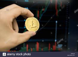 Male Businessman Hand Holding Litecoin Coin On A Background