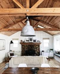 Carole S Idyllwild Cabin Has White Walls And Lots Of Warm Wood She Uses Lots Of Texture To Make Things Modern Cabin Interior Cabin Living Room Cabin Interiors
