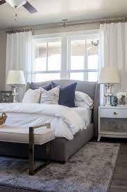 An enjoyable bedroom with a navy and grey part separated with a large weathered wood roof over the bed, grey bedding and creamy furniture. Alice Lane Home Collection Daybreak Lake Loft Gray Upholstered Bed In Master Bedroom Small Master Bedroom Transitional Bedroom Design Master Bedrooms Decor