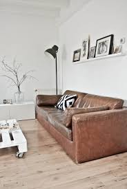 The five iron legs in a rustic, antique zinc finish feature caps to protect all types of flooring, while the reclaimed oak panel base provides a vintage flair. 10 Beautiful Brown Leather Sofas