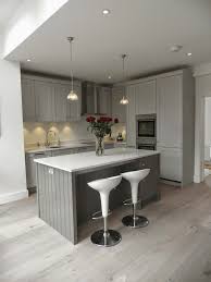 The dark gray cabinetry, light gray walls, and white subway tile backsplash make for a beautiful, neutral canvas for the bold teal blue and yellow décor accented throughout the design. Planet Furniture Beautiful Storm Grey Shaker Kitchen Farrow And Ball Mole S Breath On T Grey Kitchen Floor Grey Shaker Kitchen Open Plan Kitchen Living Room