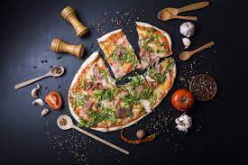 download slices italian pizza with utensils and ingredients over black kitchen worktop for free italian pizza food photo pizza