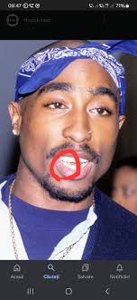 Tupac is alive . Look hes tooth👉