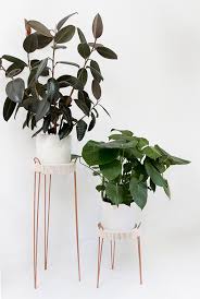 All you need is a concrete mix, a peg of wood or metal (dowel is an easier option), a bucket, tape, and paint. Sarah Sherman Samuel Diy Copper Plant Stands
