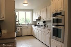 Cream cabinets, black distressed cabinets, weathered cabinets. The Best Way To Paint Kitchen Cabinets No Sanding The Palette Muse