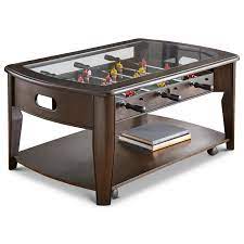 It features a clear glass top over a playing field, serving as a great resting spot for snacks and beverages. Steve Silver Diletta 1344978 Cocktail Table With Foosball Game And Included Pieces Dunk Bright Furniture Cocktail Coffee Tables