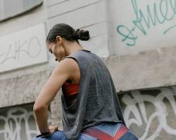 Image of woman wearing leggings, a tank top, and sneakers in Texas