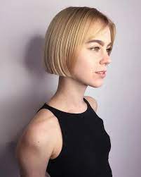 Short Blonde Blunt Bob With Parted Bangs The Latest Hairstyles For Men And Women 2020 Hairstyleology Blonde Blunt Bob Short Hair Styles Short Hair With Bangs