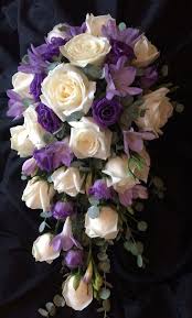 Brides Purple And Ivory Wedding Bridal Flowers In A Tear Drop Cascading Bouquet Bridal Bouquet Flowers Flower Bouquet Wedding Wedding Flowers