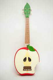 It generally employs four nylon strings. Bitten Apple Ukulele Applelele By Celentanowoodworks On Etsy Ukulele Apple Etsy