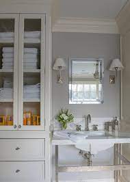 Bathroom cabinets by ashley homestore. Ivory And Gray Bathroom With Glass Door Linen Cabinet Transitional Bathroom