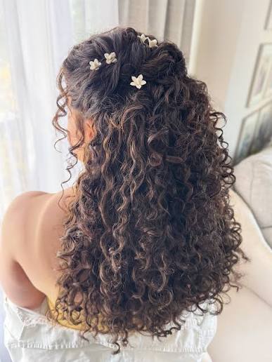 Gorgeous naturally curly ponytail using all her own hair! Peep that little  braid on the side that almost blends into the curls but brings an added  subtle detail to the style! Curly