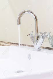 Related:modern bathroom sink faucet modern bathroom faucet chrome modern shower faucet modern bathroom sink modern bathroom vanity modern bathroom faucet black. White Sink Washbasin And Silver Curve Design Faucet In Modern Stock Photo Picture And Royalty Free Image Image 31827810