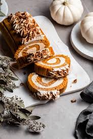 A thin pumpkin cake, rolled around in a white cream filling, then in nuts. Vegan Pumpkin Roll Crumbs Caramel