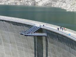 This is a video from discovery uk's 'richard hammond's big!' television program of richard visiting the kölnbrein hydroelectric dam in austria to witness its release valve being opened to spew some 20,000 liters per second. Kolnbrein Dam And Medieval Town Gmund Nina Travels
