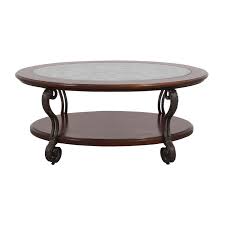 A bare coffee table isn't leading to your interior design, so make sure to make a choice with lots of room for that accent of your liking, a flower arrangement is a good choice, or even a small candlescape or silk. 90 Off Ashley Furniture Ashley Furniture Oval Glass Wood And Metal Scroll Coffee Table Tables