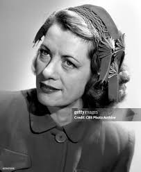 Lucille Wall models hat fashion. She stars as Portia Blake