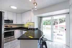 The black hanging shelves above. Curved Kitchen Island Bar Seating Black Granite Counter Tops Eclectic Kitchen Salt Lake City By Bri Interior Design Houzz