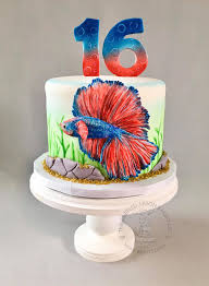 Gussy up a simple cake with toy animals and this easy birthday sign made from refrigerator magnets, straws, and pipe cleaners. Betta Fish Birthday Cake The Ruffled Apron Bakery Llc Facebook