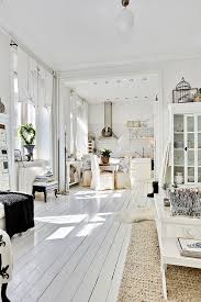 White painted floors painted brick walls white washed furniture white sheer curtains french country decorating country french cottage style decor white interior. Eye For Design Decorating With White Painted Hardwood Floors