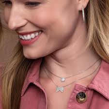 Silver angel wing necklace with blue gem