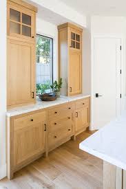 White Oak Kitchen Buffet Cabinet With White Marble Countertop And Black Hardware Kitchen Cabinets Decor Oak Kitchen Cabinets Kitchen Cabinets