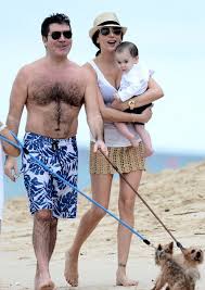 Simon Cowell Partner Lauren And Son Eric Make The Perfect Trio On Barbados Holiday Simon Cowell American Idol Winner Celebrity Couples