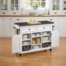 The hardwood countertop of the white kitchen island provides a warmer atmosphere and creates a more impactful look with its waterfall edge. Home Styles 44 5 In W Antique Stainless Top Kitchen Cart 5543 95 At The Home Depot White Kitchen Cart Portable Kitchen Island Interior Design Kitchen Small