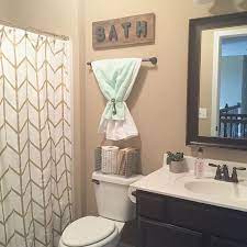 This is a small bathroom decor that is on the rise but can create an elegant look. Towels Did Colors But Great Idea Small Bathroom Decor Small Bathroom Ideas On A Budget Bathroom Decor Apartment
