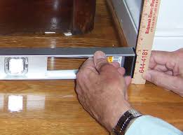 When determing how to install base cabinets on uneven floors, check for level and plumb, and add shims until the cabinets are at the same level. Sinking Uneven Floor Repair In Green Bay Appleton Oshkosh Wi Foundation Leveling Repair In Wisconsin