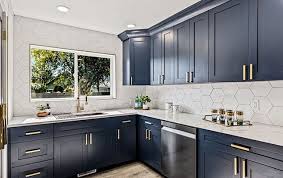 Open floor plan with dark blue island and white perimeter cabinets. Ipbqu4moh Dpwm