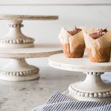 Place your cake on a cake board, and place the whole piece on top of this stand for a sweet, edible centerpiece. White Ellis Stand Magnolia Wood Cake Stand Wooden Cake Stands Beaded Cake Stand
