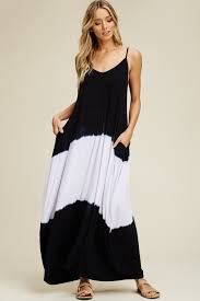 Black And Gold Tie Dye Dress Front View Young Woman Wearing Black White Tie Dye Knit Maxi Dress With Side Pockets Maxi Knit Dress Maxi Dress Tie Dye Maxi Dresses