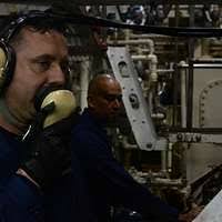 Aviation Boatswain's Mate E (Launching and Recovery Equipment) 2nd Class  John Insano uses a sound powered phone to communicate with other flight  deck crew members aboard the nuclear-powered aircraft carrier USS DWIGHT