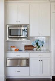 Wonderful Kitchen Features Upper Cabinets Fitted With A Microwave And Lower Cabinets Fitted With A Upper Kitchen Cabinets Kitchen Design White Kitchen Cabinets