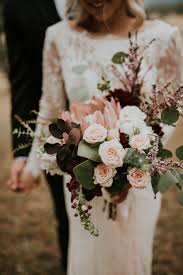 Blush peach, coral rose flowers, tropical burgundy red orchid, green fern, leaves, eucalyptus. Blush And Burgundy Wedding Lace And Lilies Blog