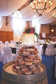 Donut Tower With Drip Wedding Cake By Jersey Kitchen And Florals By Kerin Greville Displayed On Wine Barr Wedding Donuts Wedding Food Display Wedding Desserts
