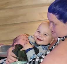 Amy shared sweet photos of her sons and herself sporting bright purple hair
