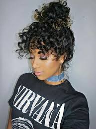 Black And Gold Hairstyles Gorgeous Black To Gold Curly Ombre Hair Is Thrown Up In A Bun Letting Us Admire The Eye Grazing Curly Bangs Curly Hair Styles Natural Hair Styles Hair Styles