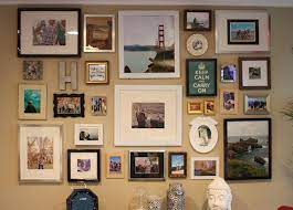 A group of a strong center line ties together contemporary photographs in frames of different sizes, left. A Fashion Gal A Fireman Wonder Wall Gallery Wall Bedroom Picture Arrangements On Wall Frames On Wall