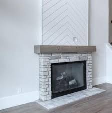 The shiplap fireplace wall adds a nice, subtle architectural interest without going overboard. Fireplace With Chevron Ship Lap Upper Brick Fireplace Makeover Herringbone Fireplace Fireplace Remodel