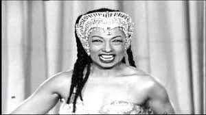 Josephine baker, 1920'lerin tipik bir zenginlik görüntüsünde, ipek bir gece elbisesi ve elmas küpeler giyen bir kaplan halısı. How Josephine Baker Went From Homeless Street Performer To International Superstar French Resistance Fighter Civil Rights Hero Open Culture