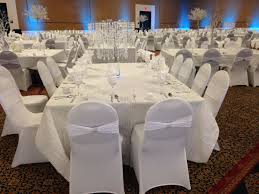 White Spandex Chair Cover With White Spandex Bands And Silver Bling Crushed Table Cloth And Crystal Chande Chair Covers Wedding White Chair Covers Chair Covers