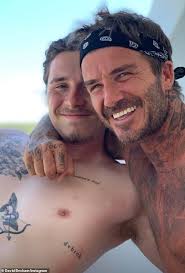Battle of the Beckham tattoos: Footballer David, 48, and son Brooklyn, 24,  rack up 100 inkings each but what do they all mean?