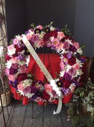 A spray made with a mixture of colours. Funeral Wreath Loving Daughter With Shades Of Purple Enchanted Florist