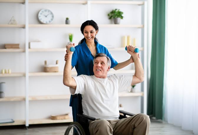 Patient working with a physiotherapist during rehabilitation