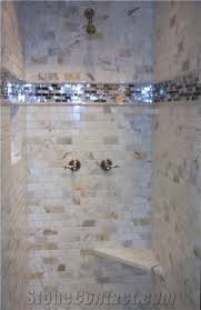 In an illinois cottage designed by timothy corrigan, works by joan miró brighten a bath, which features a calacatta marble shower, a kallista tub, and ann sacks mosaic floor tile; Calacatta Gold Marble And Glass Mosaic Shower Wall Aplication From United States Stonecontact Com