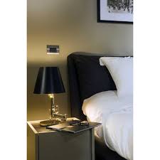 Lighting plays a significant role in crafting an inviting bedroom design scheme.beyond just setting the right mood or making reading in bed more enjoyable, it can add a dose of style to your bedside table arrangement. Flos Guns Bedside Table Lamp Gold Chiarenza Store