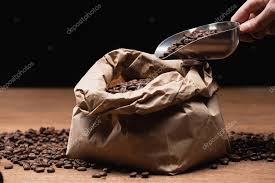 Perfect cup of great where to buy fresh roasted coffee beans near me comes down to this coast to coast coffee is giving the. Cropped View Of Man Holding Spatula With Fresh Roasted Coffee Beans Near Paper Bag On Wooden Table Isolated On Black Premium Stock Photo Royalty Free